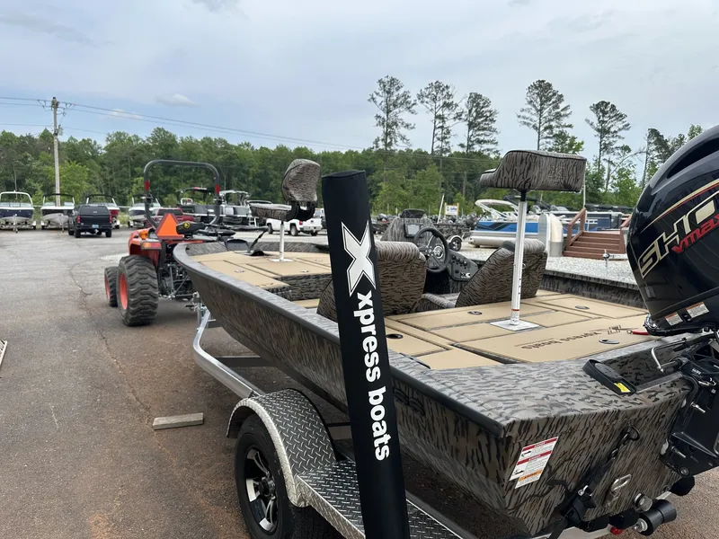 Slide: The Image of Xpress H17 boat 2026 parked on trailer outdoors. - 5