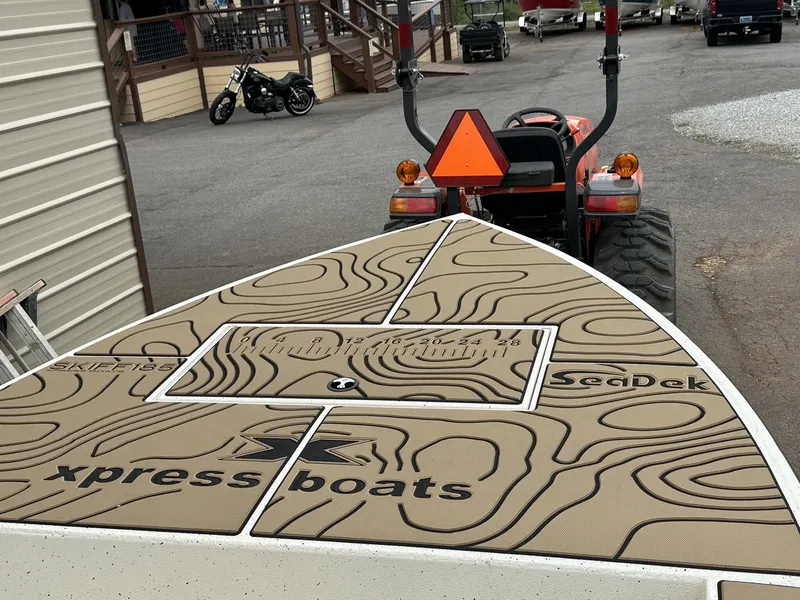 Slide: The Image of 2026 Xpress Skiff boat with SeaDek flooring, on trailer. - 5