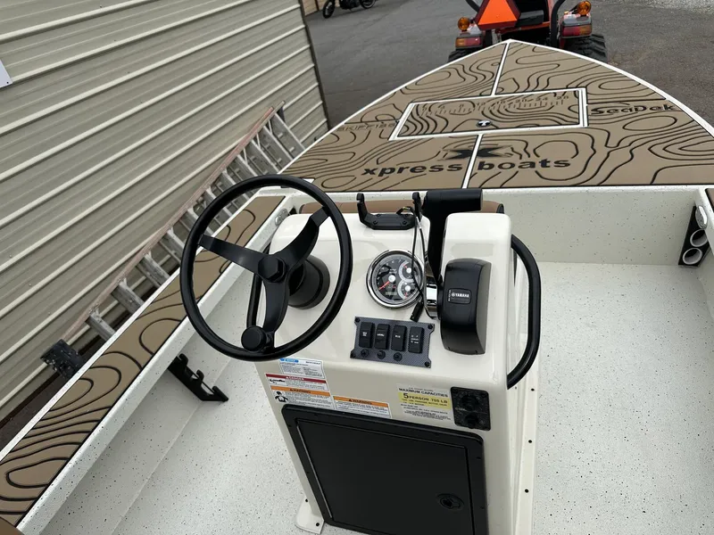 Slide: The Image of Interior view of a 2026 Xpress Skiff with steering console. - 6