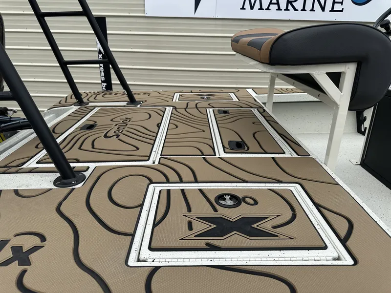 Slide: The Image of 2026 Xpress Skiff with textured deck and seating bench. - 7