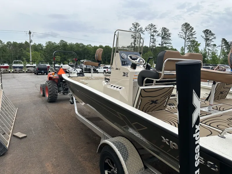 Slide: The Image of 2026 Xpress Hyper-Lift Bay Series boat on trailer outdoors. - 5
