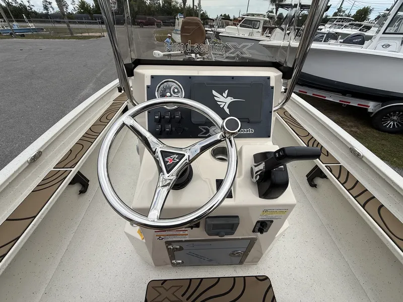 Slide: The Image of Steering console of the 2026 Xpress X23B Bay Lounge boat. - 14