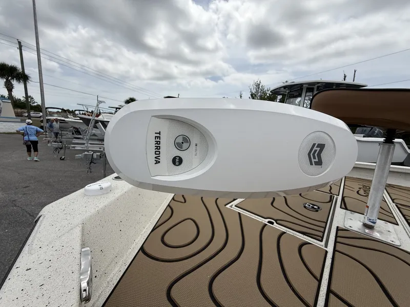 Slide: The Image of Xpress X23B Bay Lounge 2026 with Terrova motor on boat deck. - 13