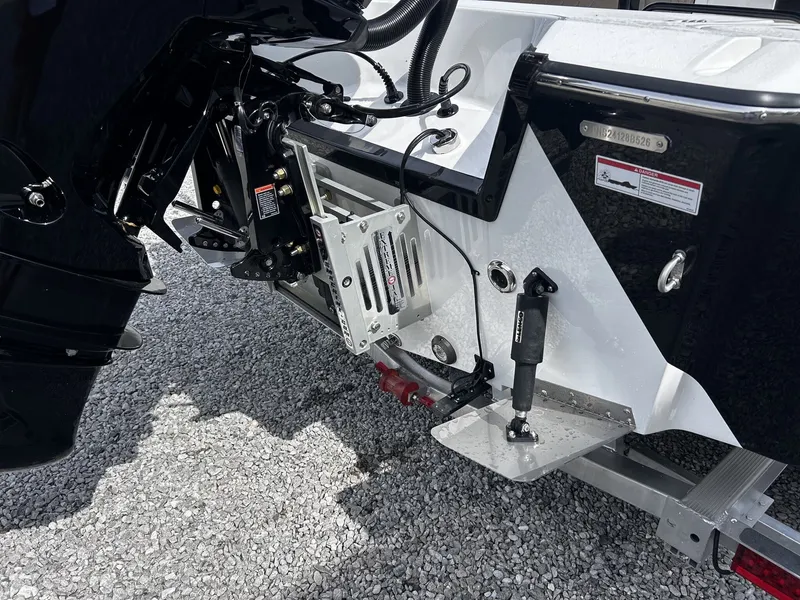 Slide: The Image of Blazer Bay 2440 2026 boat motor and rear view on gravel. - 12