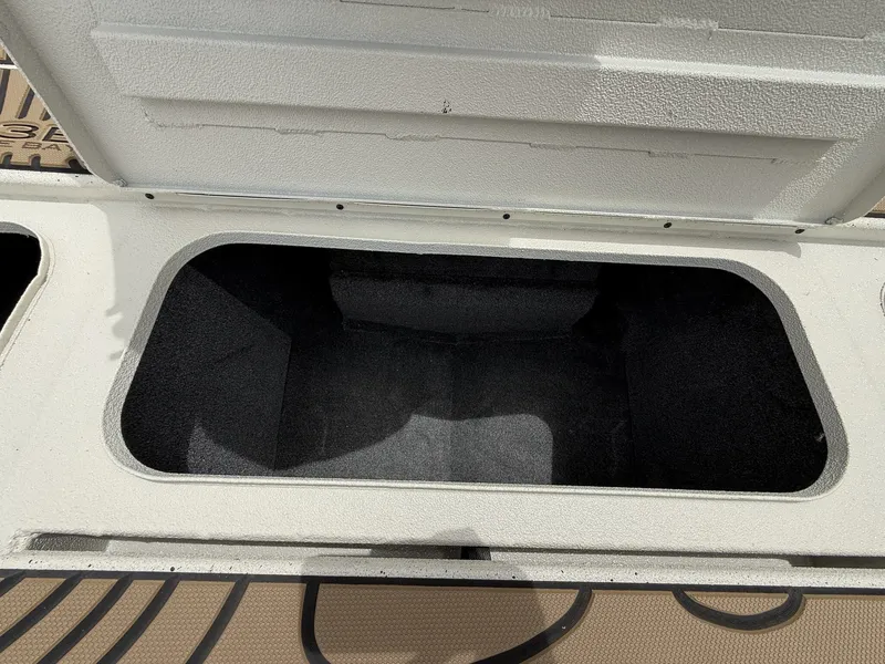 Slide: The Image of Open storage compartment in Xpress X23B Bay Lounge boat, 2026 model. - 9