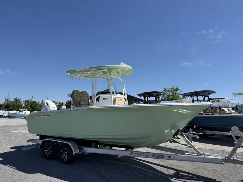 The Image of 2026 Sea Pro 222 Center Console boat on trailer, blue sky. - 1