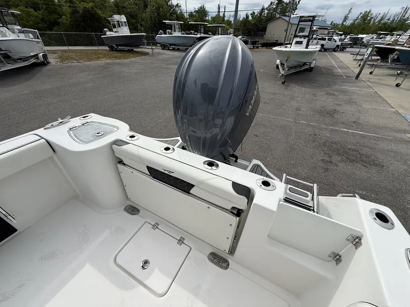 Slide: The Image of 2026 Tidewater 232 CC Adventure with outboard motor at dock. - 13