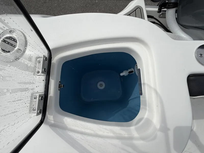 Slide: The Image of Tidewater 232 CC Adventure 2026, open storage compartment with blue interior lining. - 14