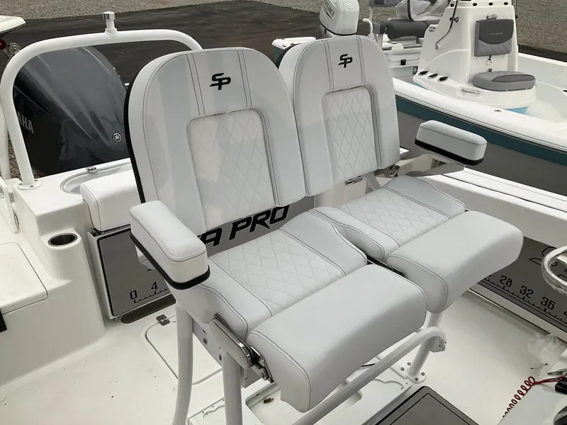 Slide: The Image of 2024 Sea Pro 222 Center Console, white dual seats in cockpit. - 8