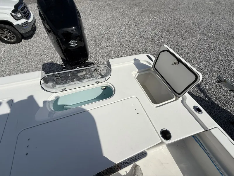 Slide: The Image of 2026 Sea Pro 250 Bay boat with storage compartments and motor. - 12