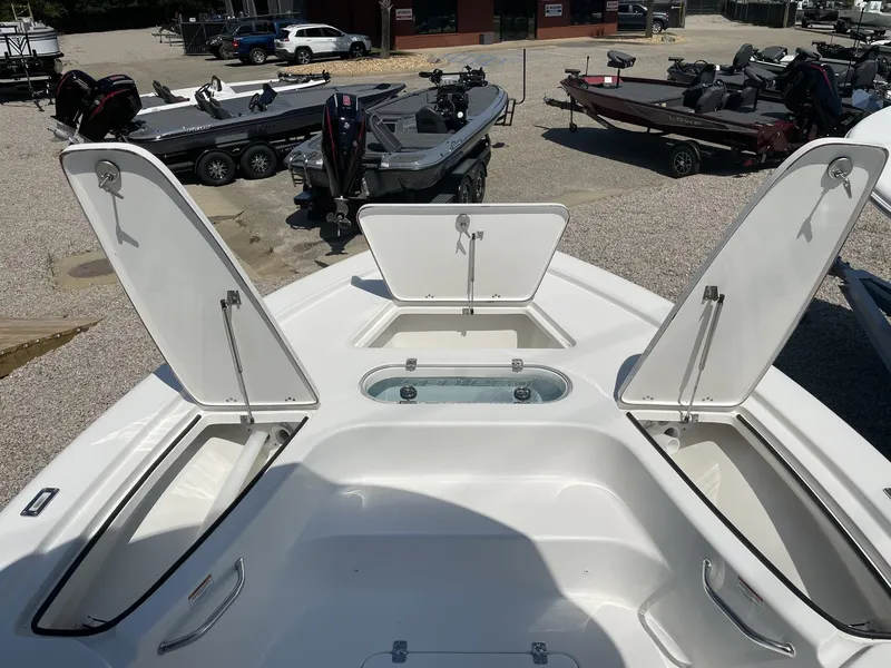 Slide: The Image of 2026 Sea Pro 250 Bay boat with open storage compartments at dock. - 19