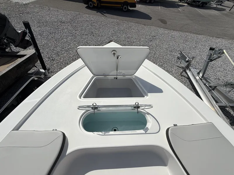 Slide: The Image of 2026 Sea Pro 250 Bay boat with open storage compartments. - 7