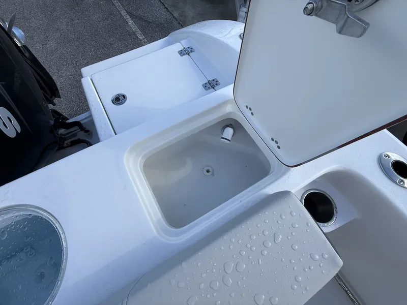 Slide: The Image of Interior view of Sea Pro 242 boat with storage and engine. - 14