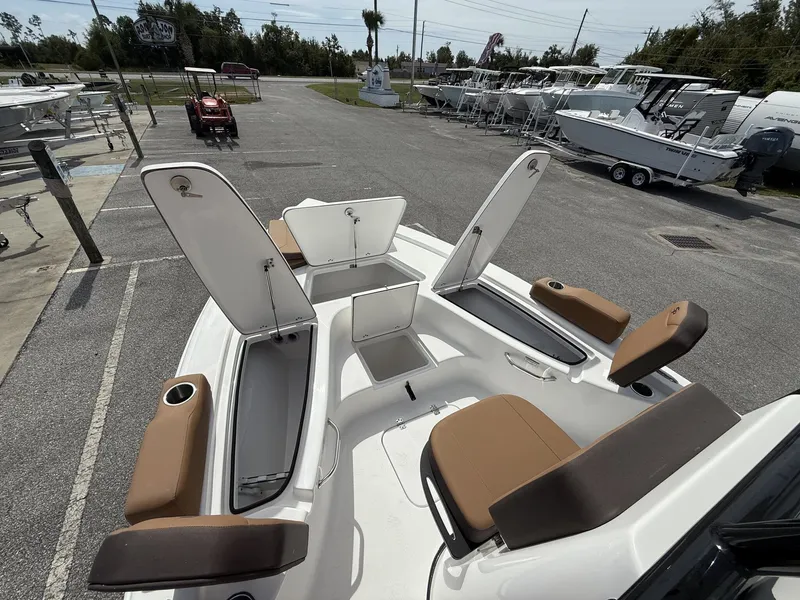 Slide: The Image of 2026 Sea Pro 230 Bay boat with open storage compartments at dock. - 6