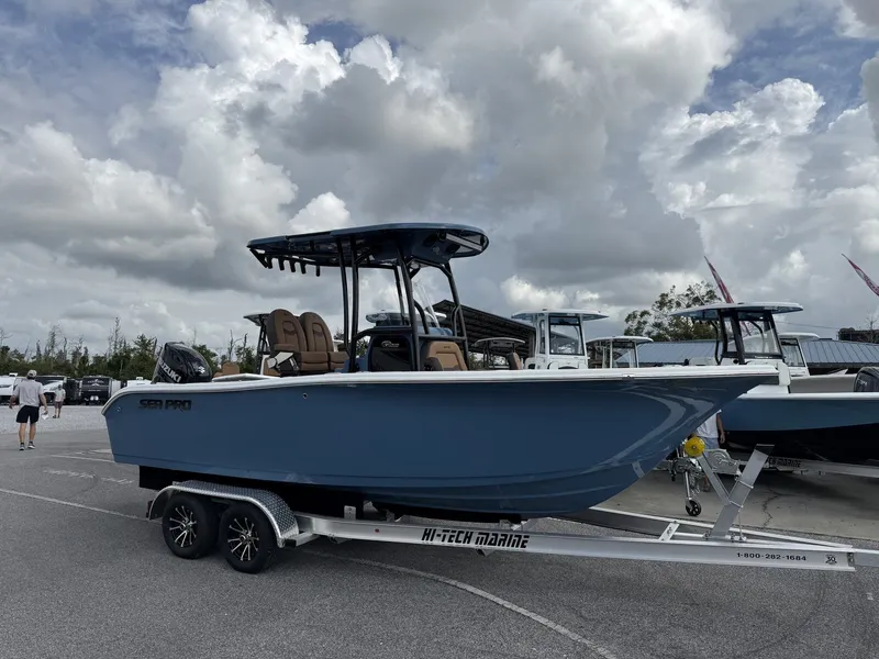 The Image of 2026 Sea Pro 222 Center Console boat on trailer, cloudy sky. - 1