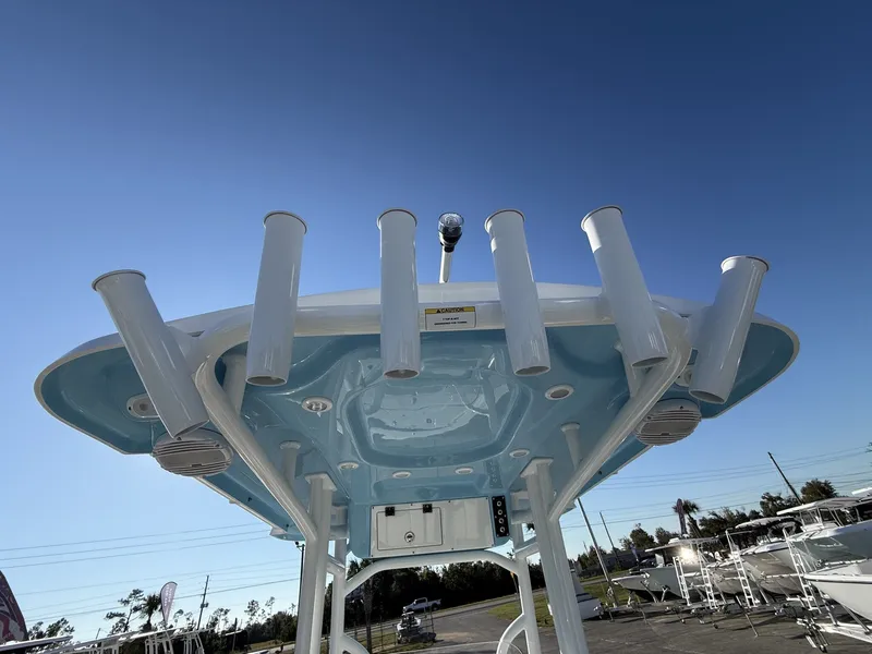 Slide: The Image of Sea Pro 230 Bay 2026 boat with rod holders and blue sky. - 12