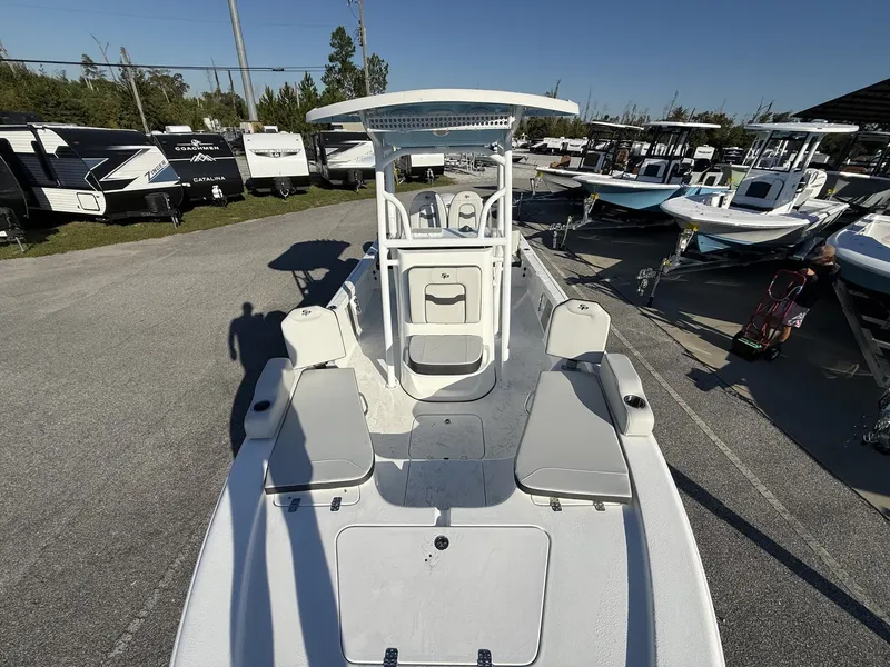 Slide: The Image of 2026 Sea Pro 230 Bay boat displayed in a parking lot. - 8