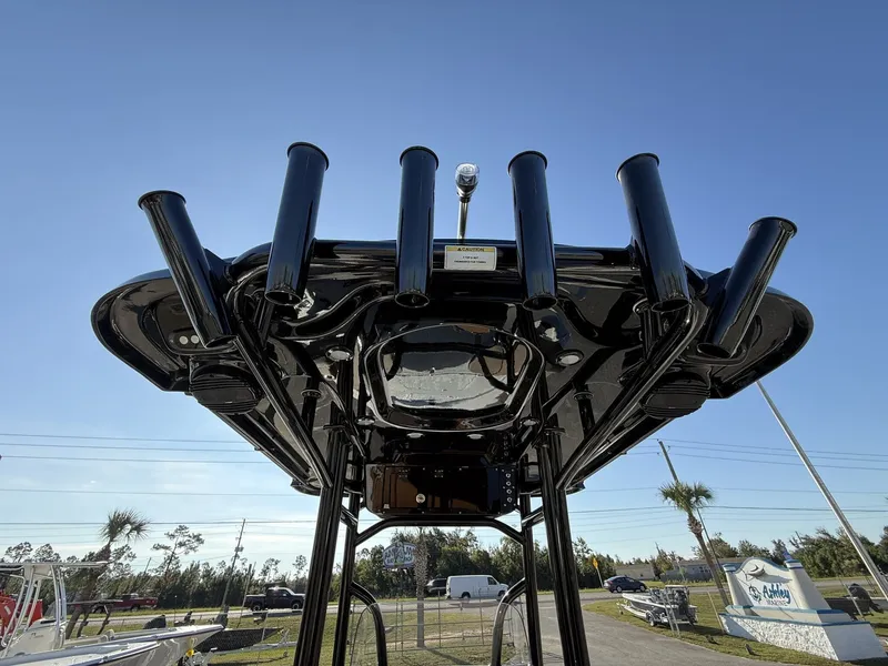 Slide: The Image of 2026 Sea Pro 230 Bay with black T-top and rod holders. - 13