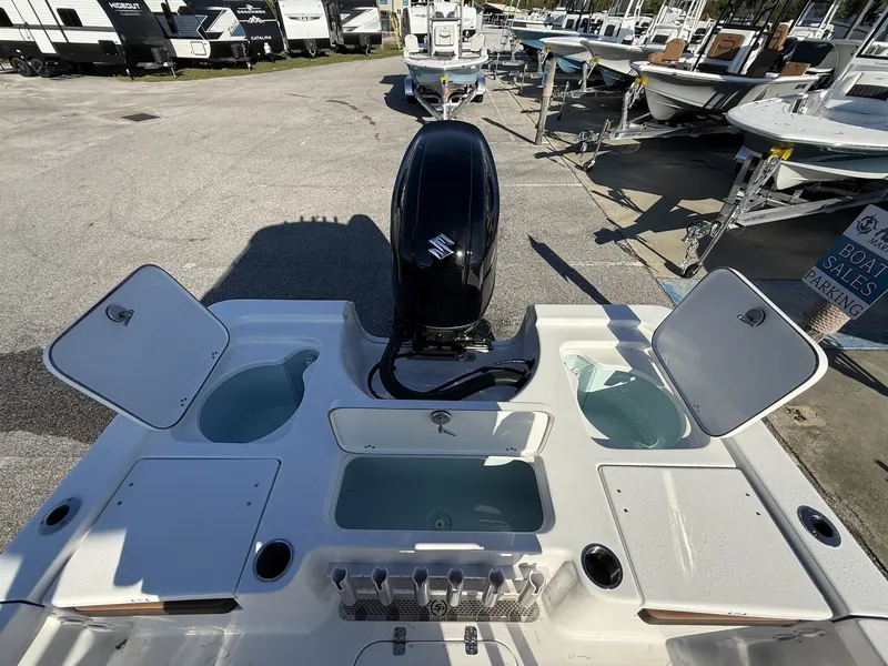 Slide: The Image of Rear view of a 2026 Sea Pro 230 Bay boat with motor and storage compartments. - 15
