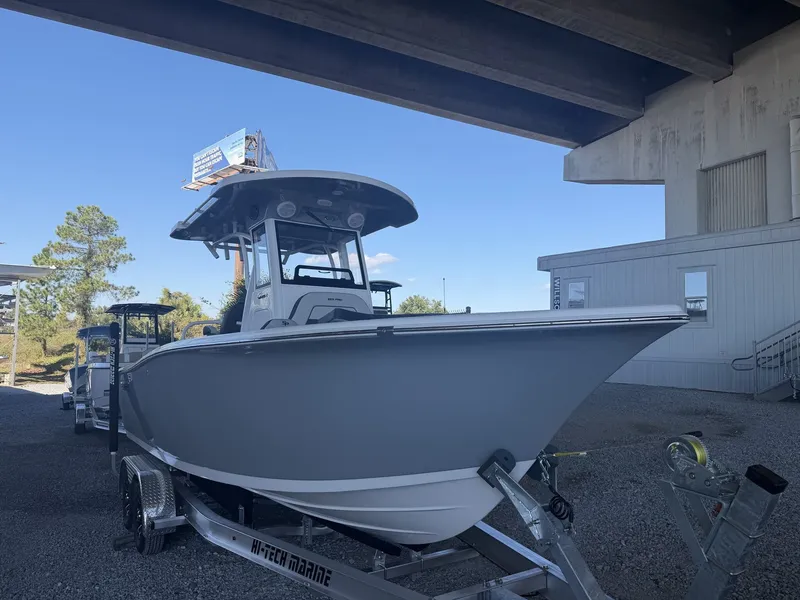Slide: The Image of 2026 Sea Pro 245FLX R boat on trailer under bridge. - 11