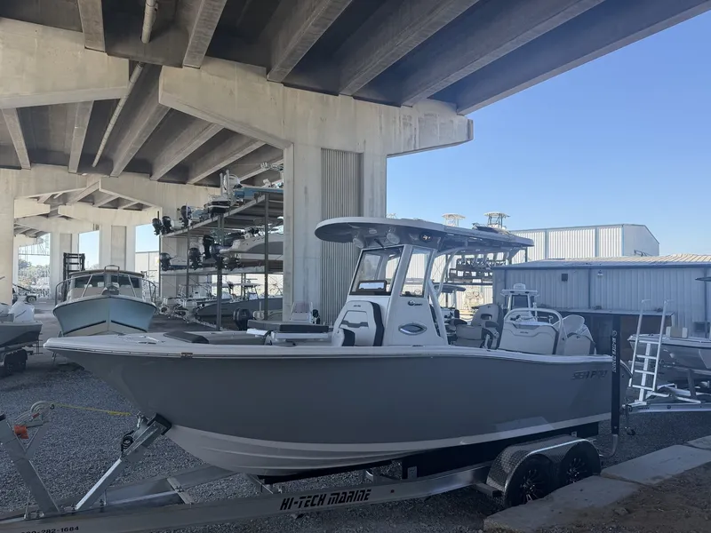 Slide: The Image of 2026 Sea Pro 245FLX R boat on trailer under bridge. - 3