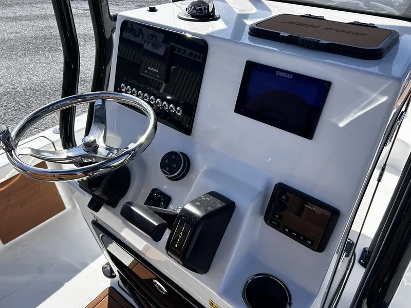 Slide: The Image of 2026 Sea Pro 230 Bay helm with modern controls and displays. - 19