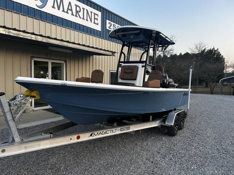 Slide: The Image of 2026 Sea Pro 230 Bay boat on trailer outside marine shop. - 6