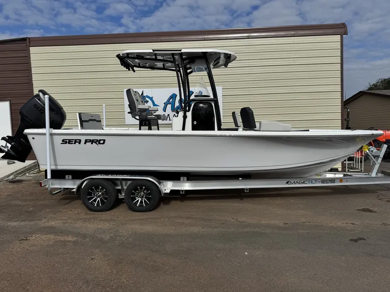 The Image of 2026 Sea Pro 250 Bay boat on trailer in front of building. - 1