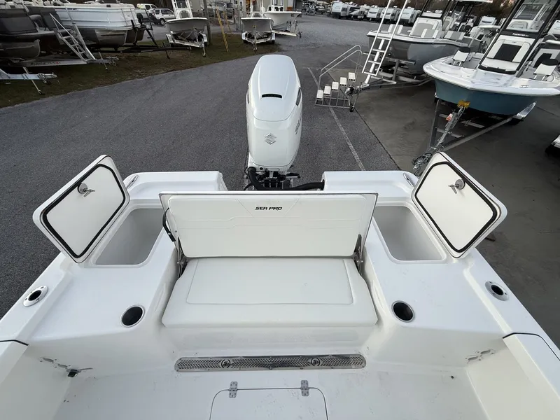 Slide: The Image of Rear view of a 2026 Sea Pro 250 Bay boat at the marina. - 12