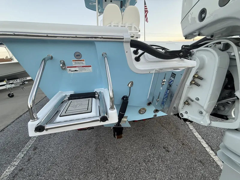 Slide: The Image of Rear view of a 2026 Sea Pro 250 Bay boat with blue finish. - 3