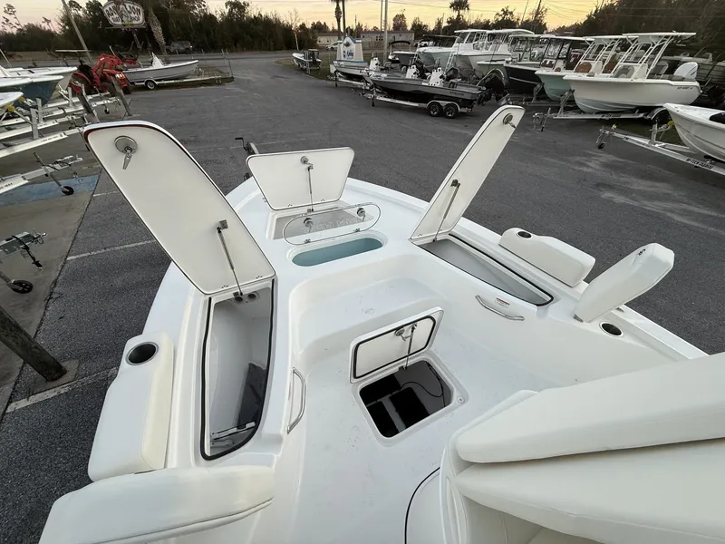Slide: The Image of 2026 Sea Pro 250 Bay boat with open storage compartments at the dock. - 7