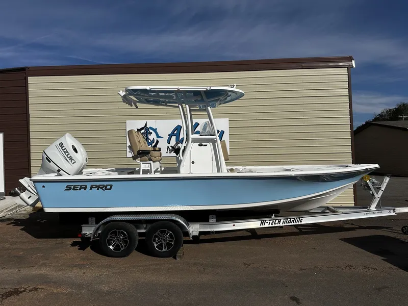 The Image of 2026 Sea Pro 230 Bay boat on trailer in front of building. - 1