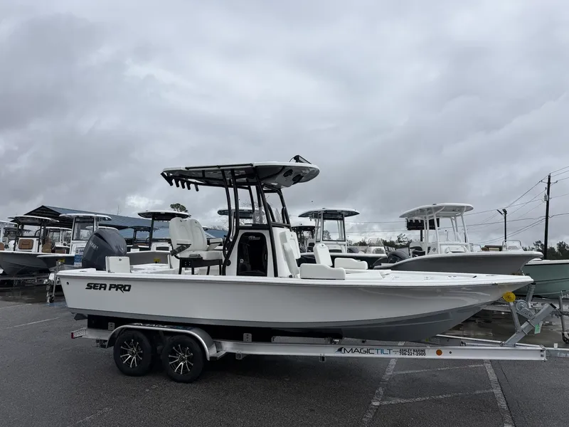The Image of 2026 Sea Pro 230 Bay boat on trailer under cloudy sky. - 1