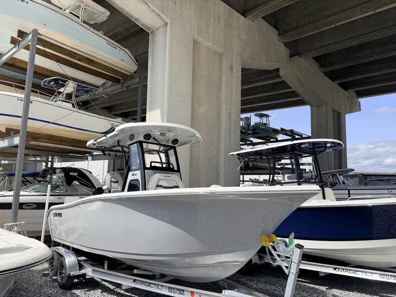 The Image of 2026 Sea Pro 242 DLX boat on trailer under bridge. - 1