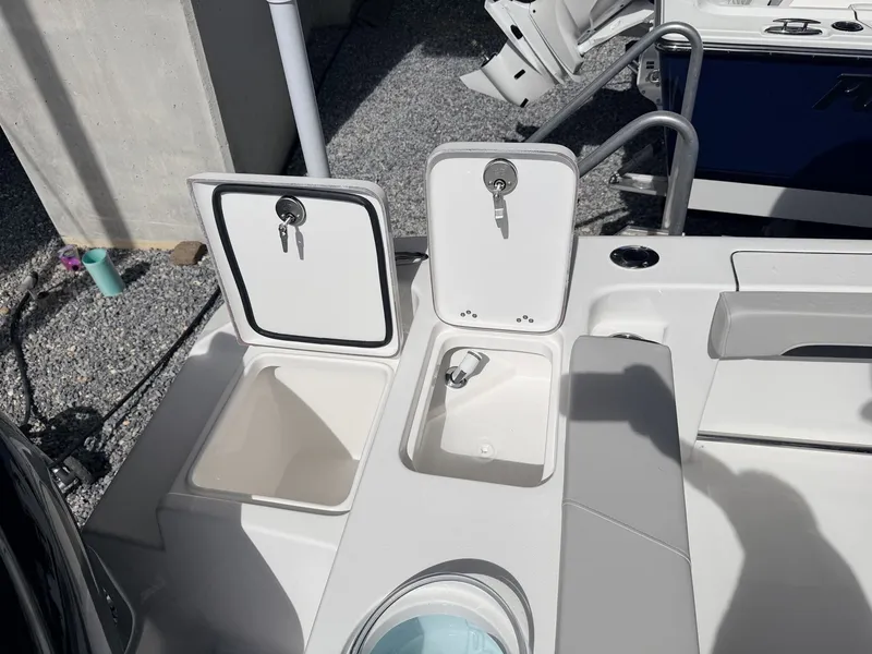 Slide: The Image of 2026 Sea Pro 242 DLX boat with storage compartments and keys. - 15