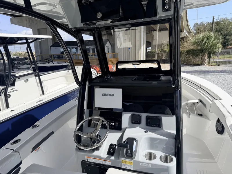 Slide: The Image of Interior view of 2026 Sea Pro 242 DLX with Simrad controls. - 17