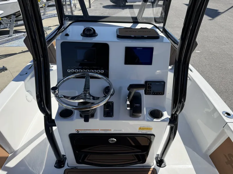 Slide: The Image of 2026 Sea Pro 230 Bay helm with modern controls and displays. - 11