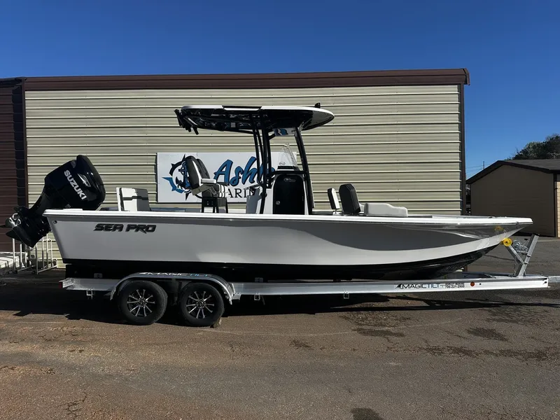 The Image of 2026 Sea Pro 250 Bay boat on trailer outside warehouse. - 1