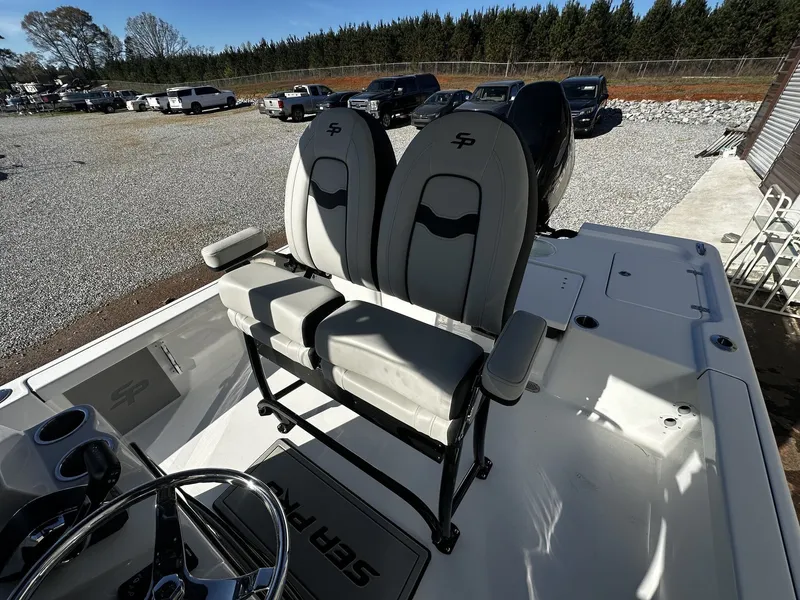 Slide: The Image of 2026 Sea Pro 250 Bay boat with dual seats and steering wheel. - 6