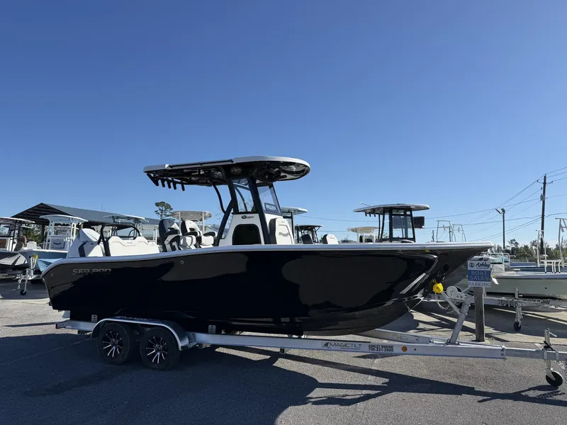 The Image of 2026 Sea Pro 245FLX boat on trailer under sunny skies. - 1