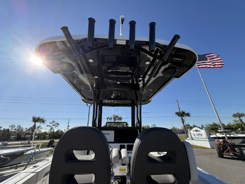 Slide: The Image of 2026 Sea Pro 245FLX boat with sun canopy and American flag. - 15