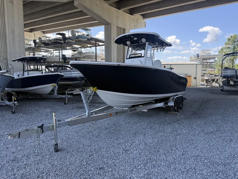 Slide: The Image of 2026 Sea Pro 242 DLX boat on trailer under bridge. - 4