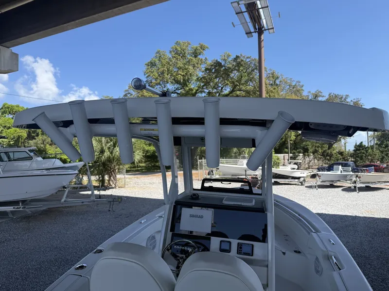 Slide: The Image of 2026 Sea Pro 242 DLX boat with rod holders and electronics. - 7