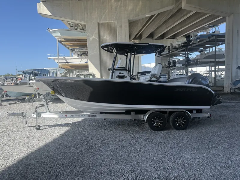 The Image of 2026 Sea Pro 222 Center Console boat on trailer at marina. - 1