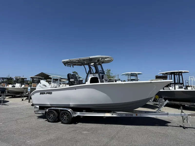 The Image of 2026 Sea Pro 242 DLX boat on trailer outdoors. - 1
