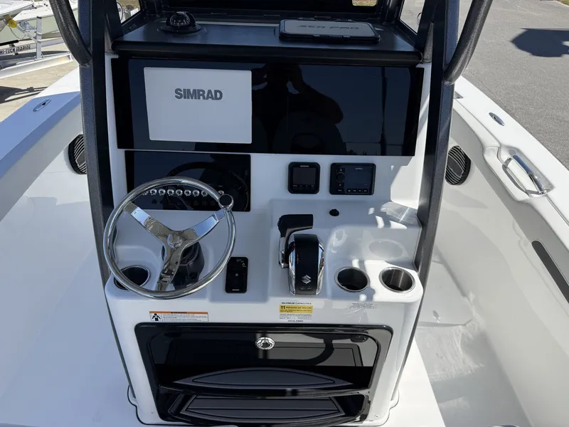Slide: The Image of Sea Pro 242 DLX 2026 helm with Simrad display and controls. - 10