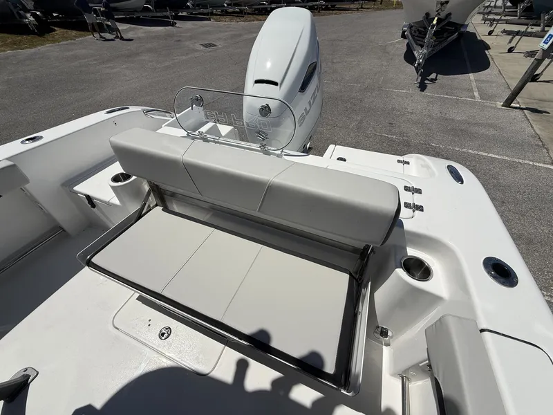 Slide: The Image of 2026 Sea Pro 242 DLX boat with seating and motor. - 13