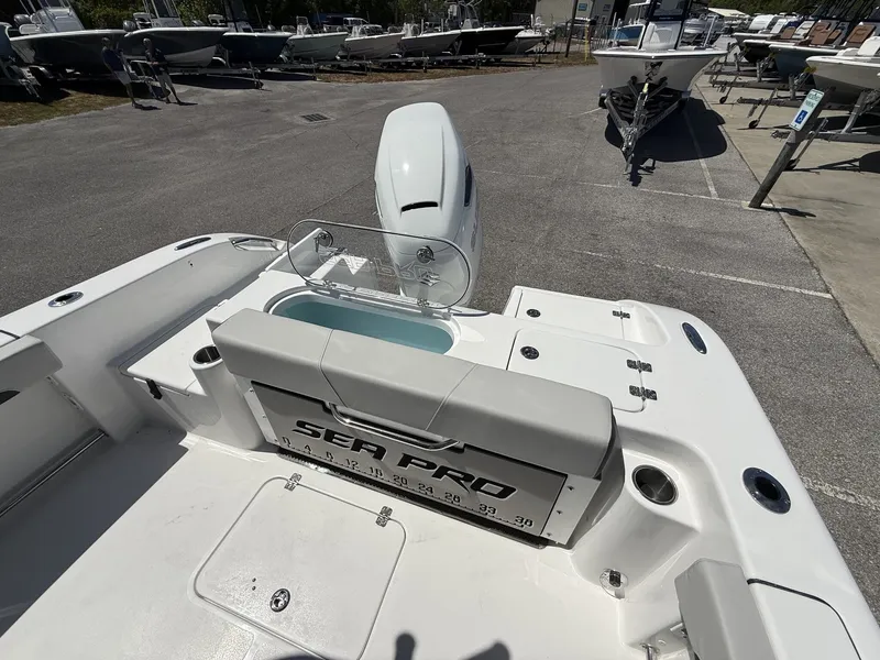 Slide: The Image of 2026 Sea Pro 242 DLX boat rear view in parking lot. - 14