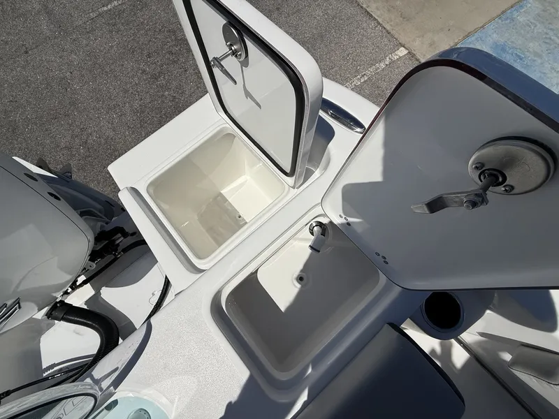 Slide: The Image of Interior view of 2026 Sea Pro 242 DLX boat with open storage compartments. - 15