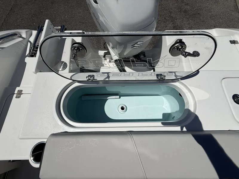 Slide: The Image of 2026 Sea Pro 242 DLX boat with open storage compartment. - 16